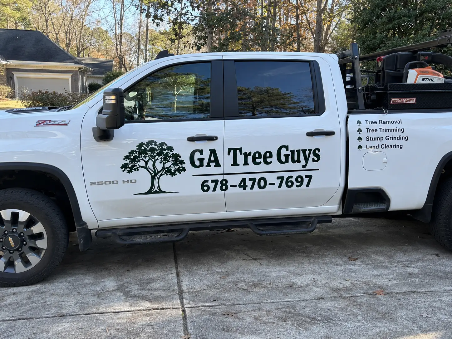 Georgia Tree Guys work truck with logo and phone number